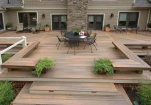Multilevel backyard deck with built-in benches, broad central steps, planters, and an outdoor dining table.